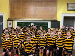 Happy school children in rugby uniforms at Inchmarlo primary school.