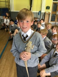 Young student holding a mouse at Inchmarlo School in Scotland.
