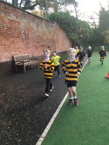 Students playing outside in playground with sports uniforms.