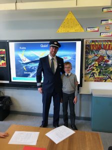 A teacher with a student in a classroom in Inchmarlo School, highlighting education excellence.