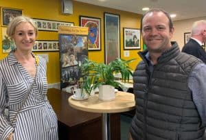 A cheerful woman and a man enjoy their time at Inchmarlo community event.