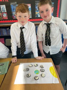 Two schoolboys in uniform at Inchmarlo School engaging in a classroom activity.