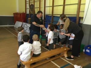 Children receiving music lesson at Inchmarlo, a nurturing educational environment.